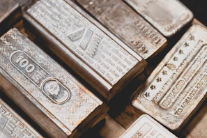 Silver bullion bars arranged neatly with a soft glow highlighting their texture.