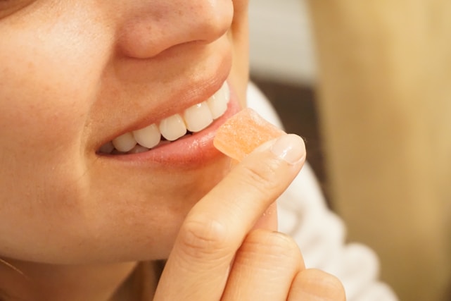 woman holding orange and white candy