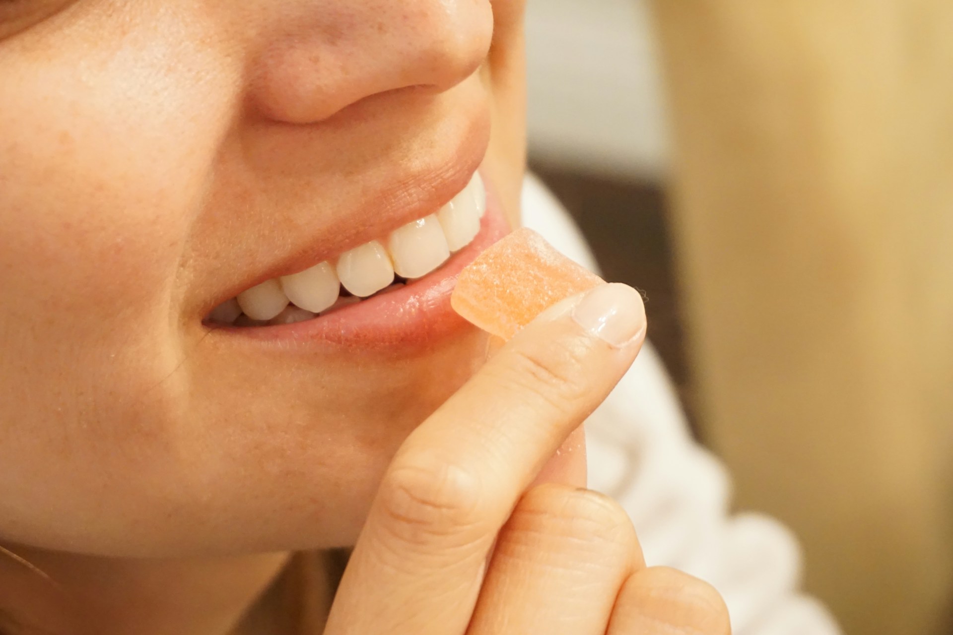 woman holding orange and white candy