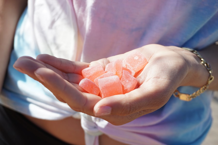 Hand holding cannabis CBD gummies in natural sunlight