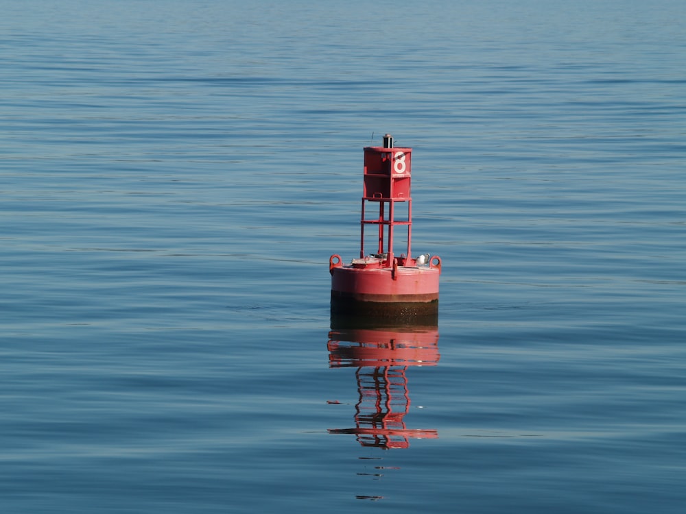 pink and white concrete tower on body of water during daytime