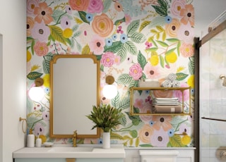 a bathroom with a floral wallpaper and a white toilet