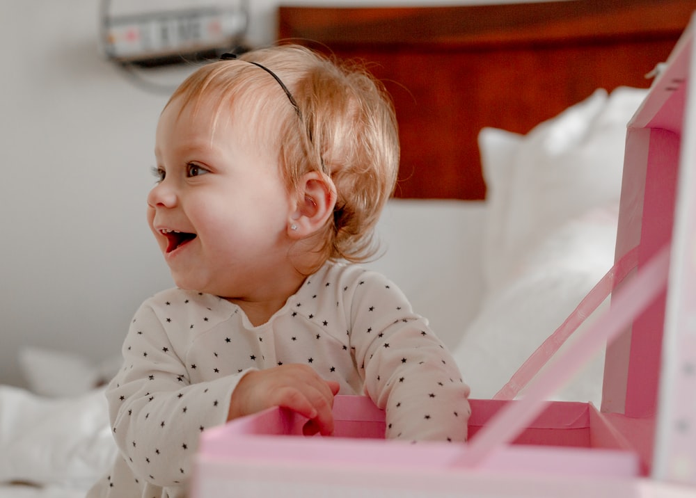 a little girl that is sitting in a bed