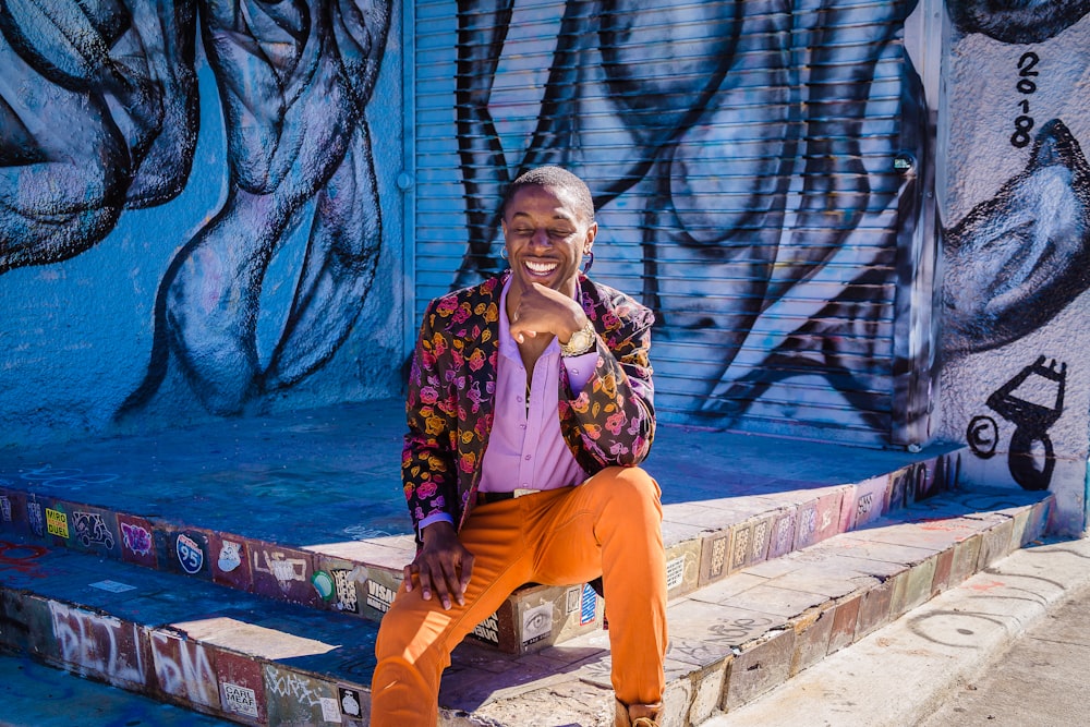 a man sitting on a step talking on a cell phone