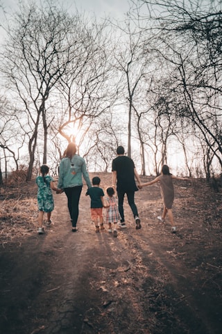 group of people standing on brown dirt road during daytime