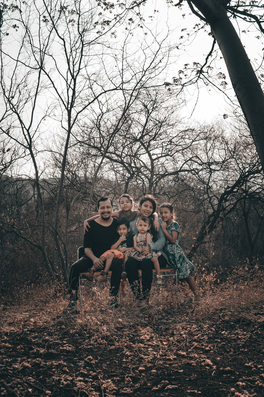 group of people sitting on brown grass field