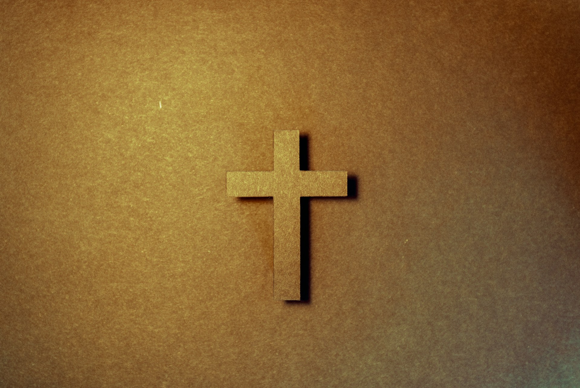 brown cross on brown surface