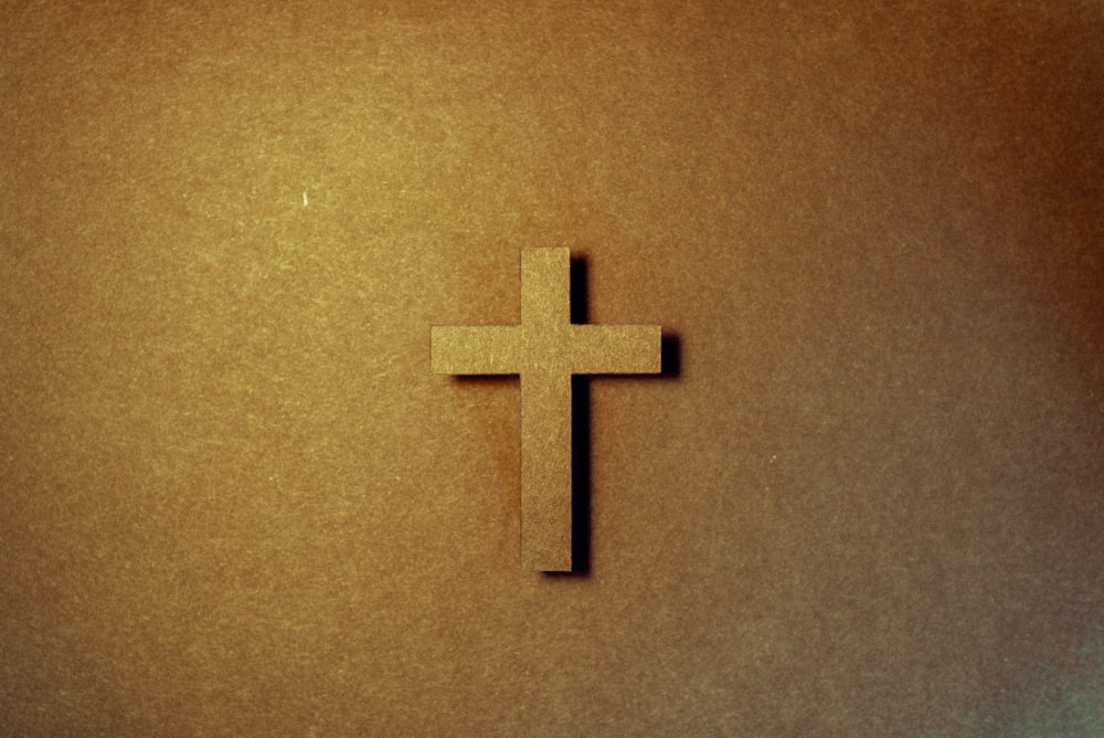 brown cross on brown surface