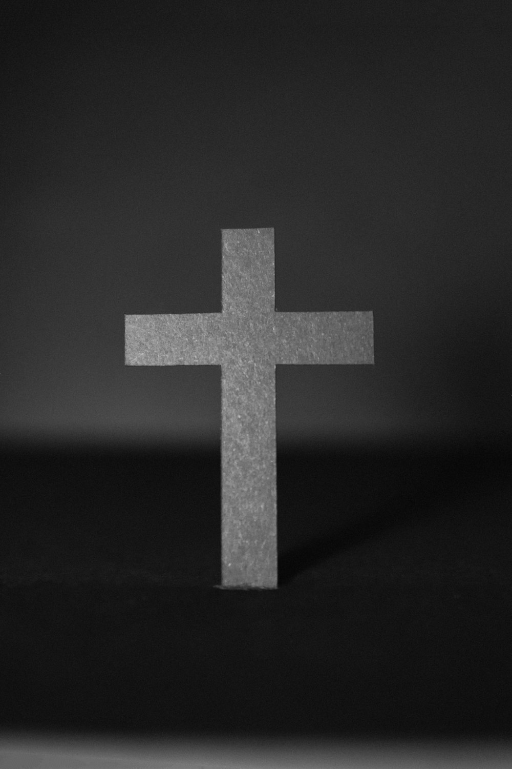 white cross on black surface