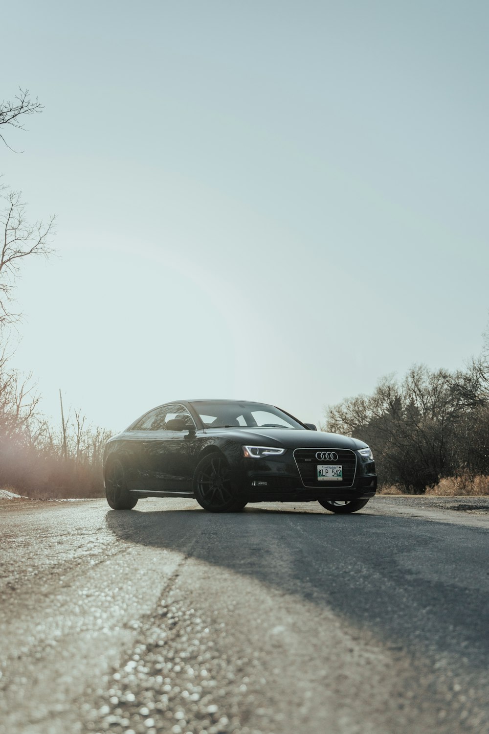 black sedan on road during daytime