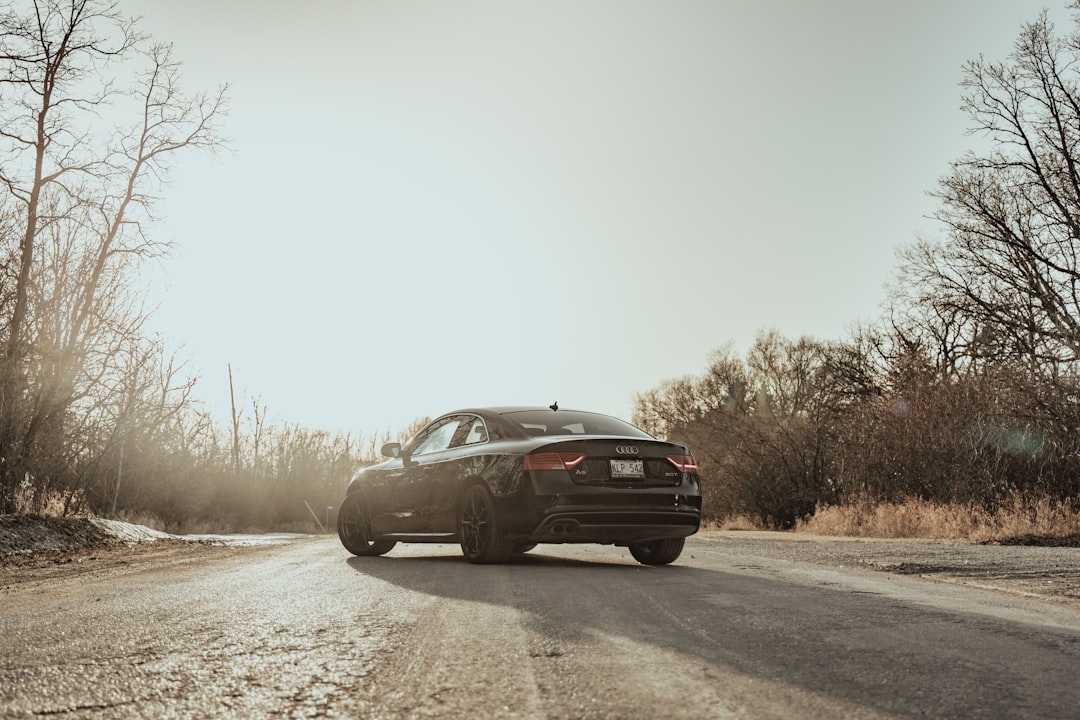 black sedan on road during daytime