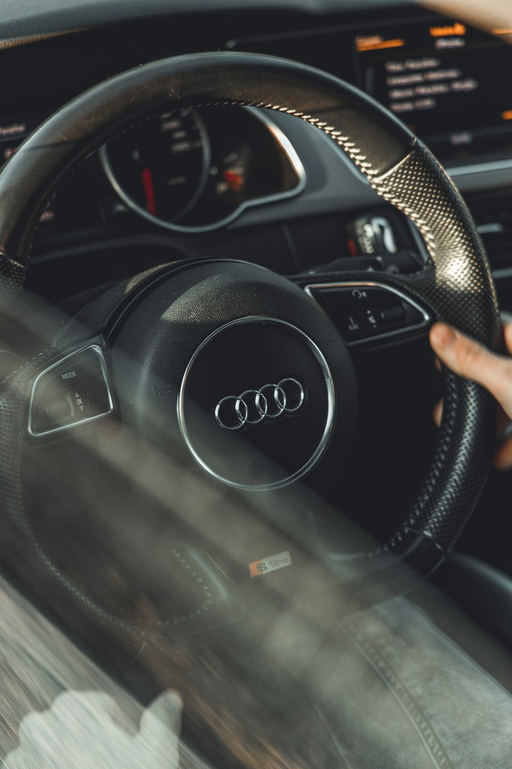 person holding black jeep steering wheel