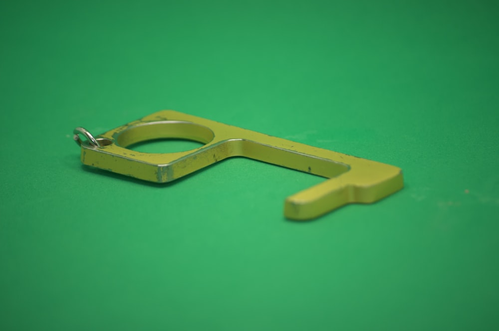 gold key on green surface