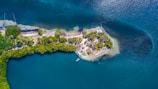 Aerial view capturing the lush island surrounded by vibrant blue marine protected zones.