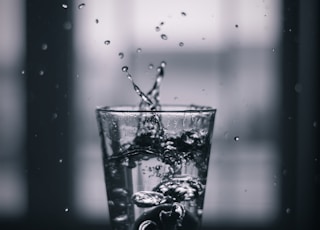 water pouring on clear drinking glass