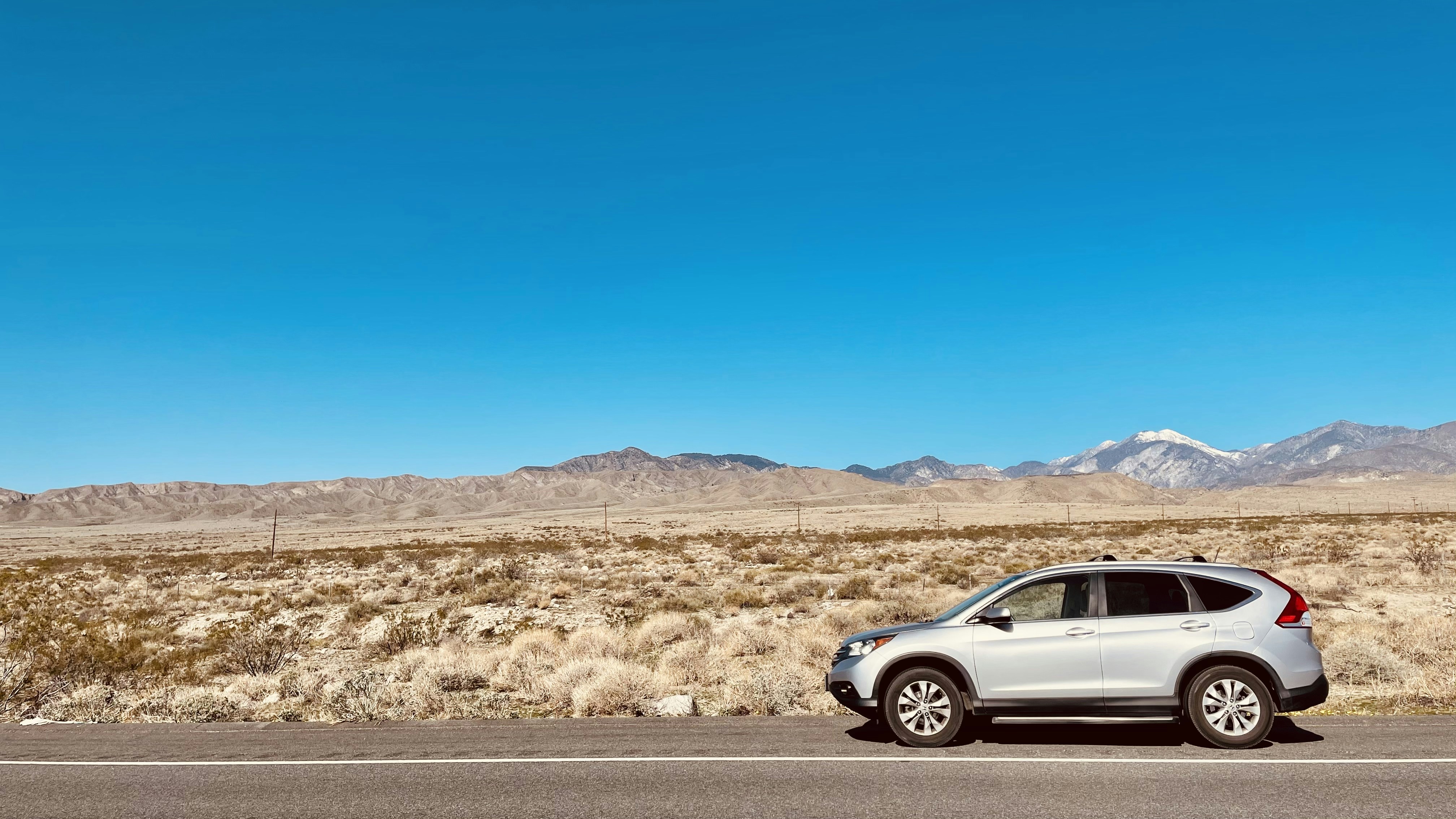 silver sedan on road during daytime