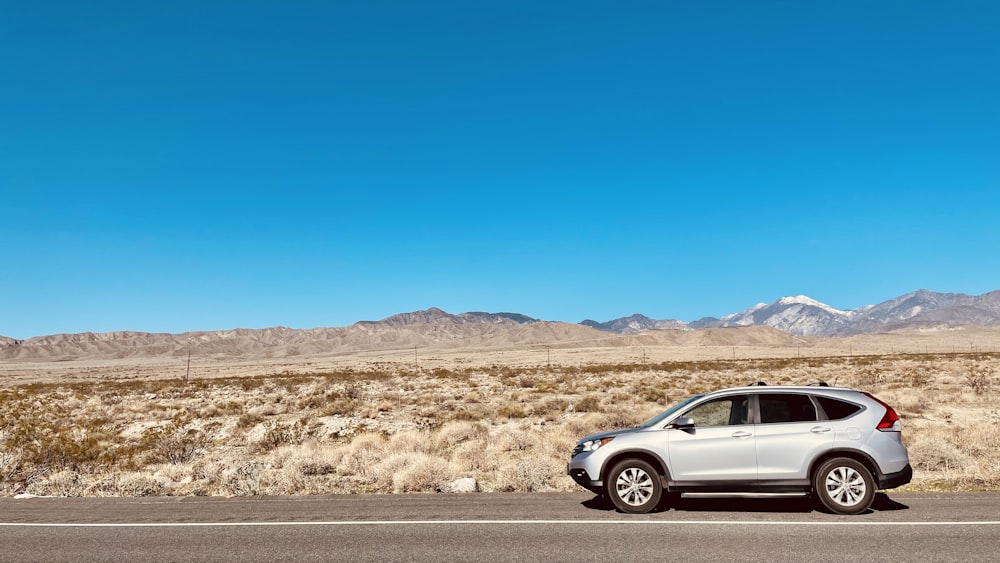 silver sedan on road during daytime