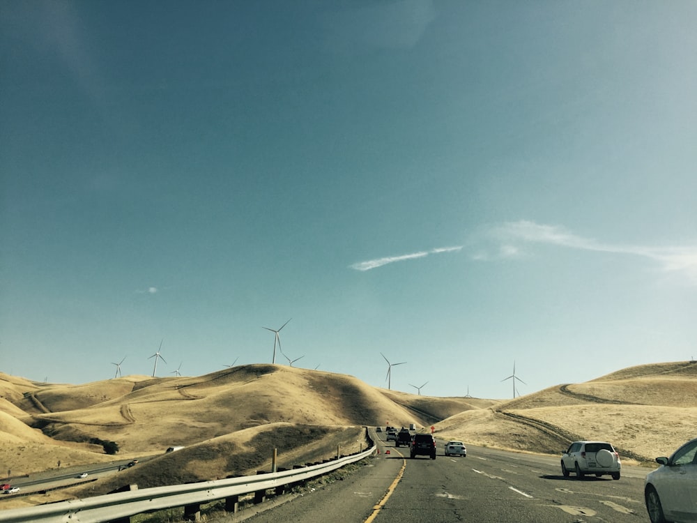 cars on road under blue sky during daytime