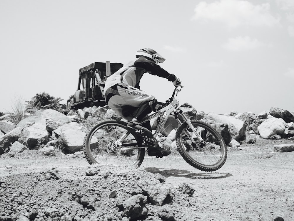 man riding on motorcycle on rocky mountain during daytime