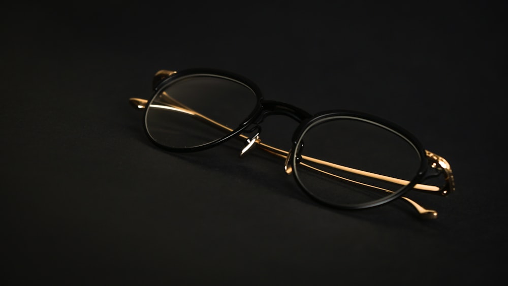 silver framed eyeglasses on black surface