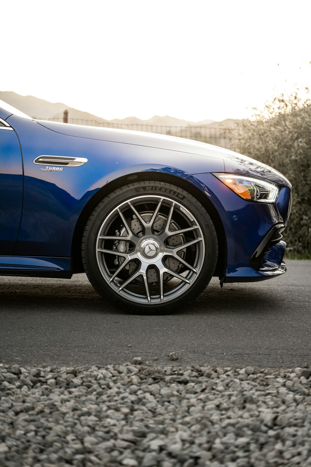 blue car on black asphalt road during daytime