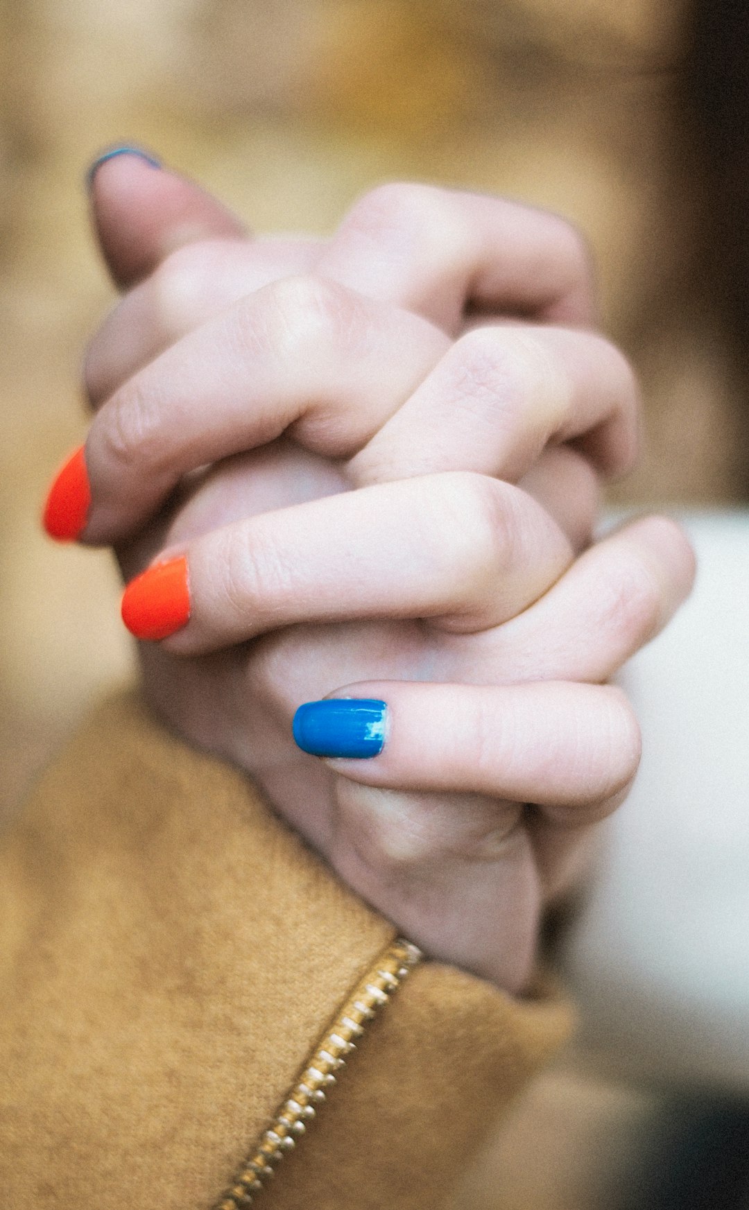 person with blue manicure and gold ring