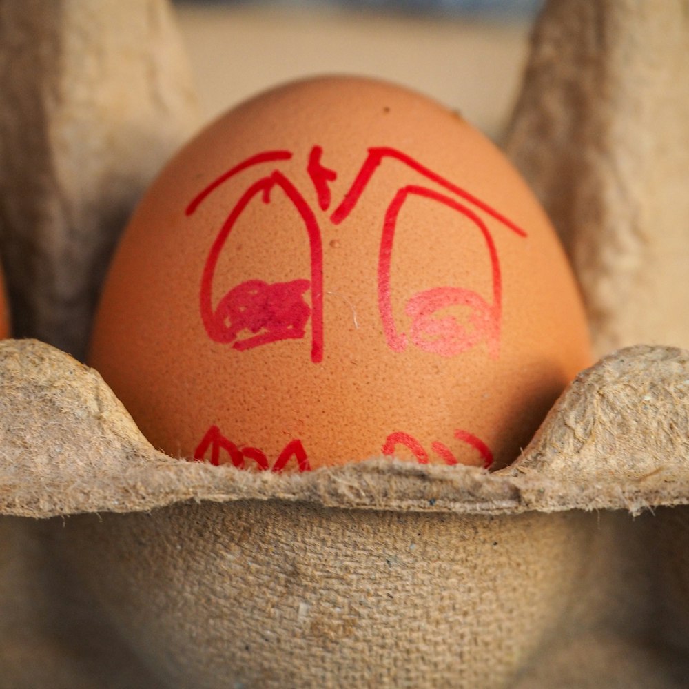 pink egg on white textile