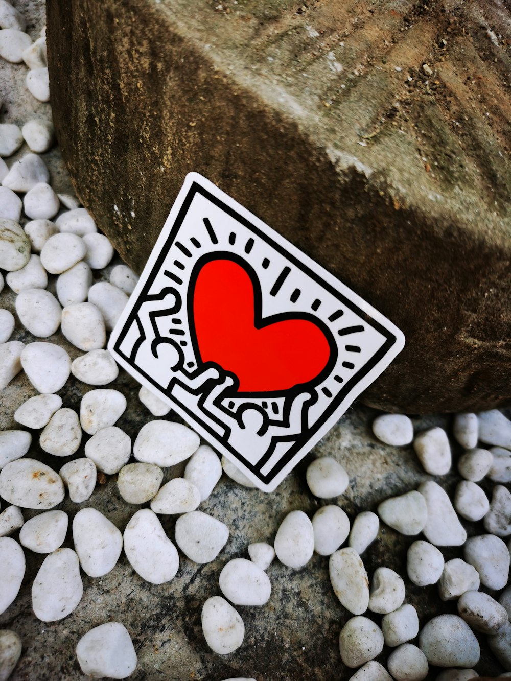 red and white heart on gray stone