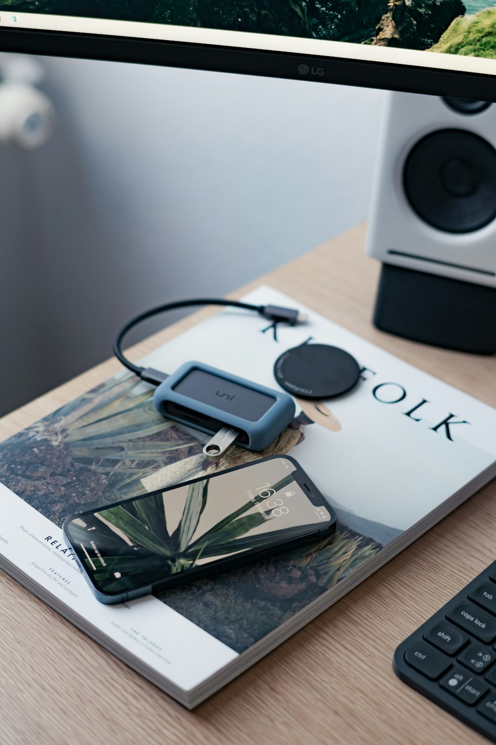 black and silver portable speaker beside white sony vaio laptop computer