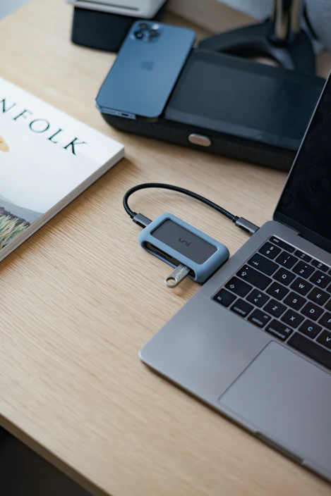 Person working on a modern notebook in a bright, minimalist workspace