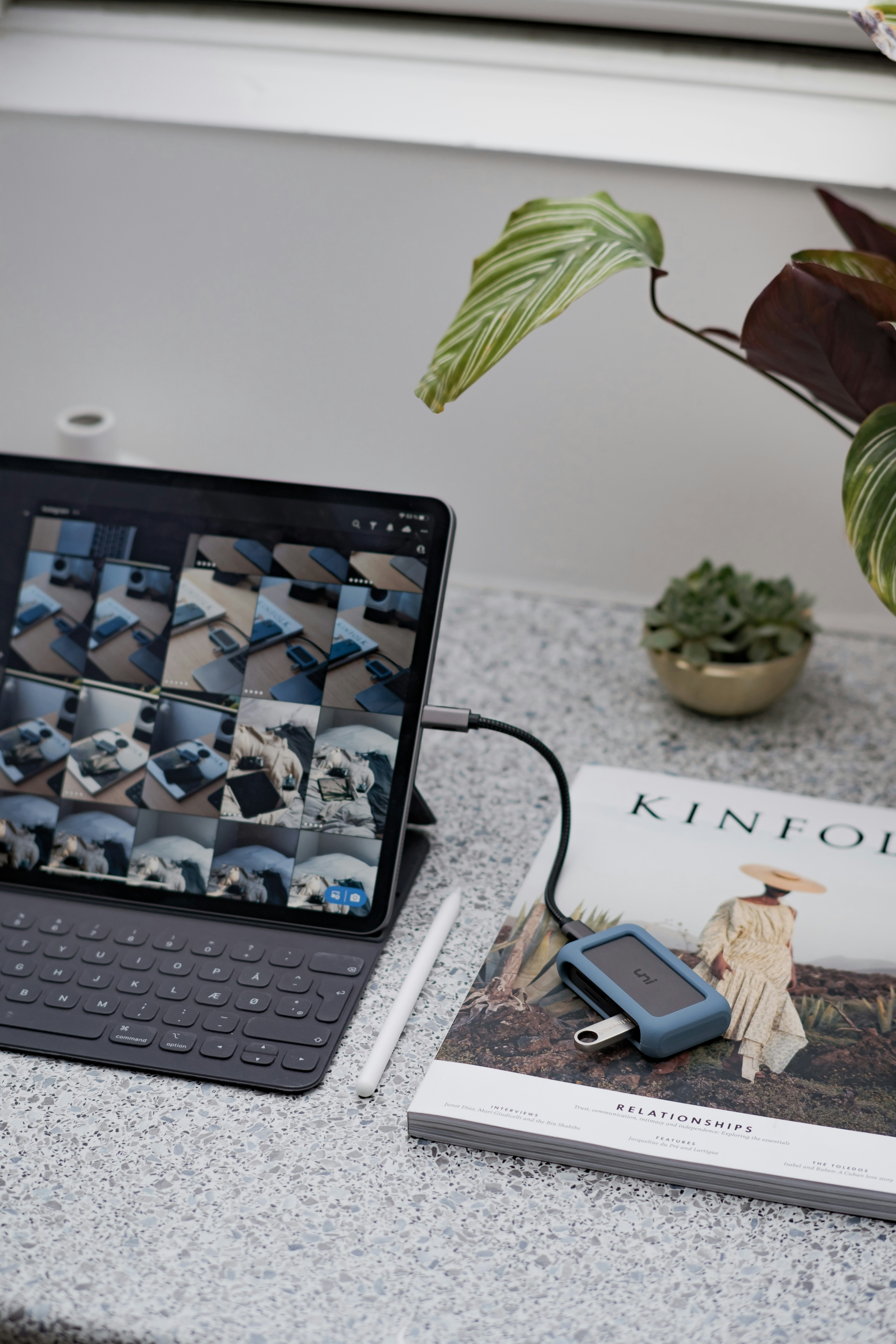 black ipad with keyboard on white table