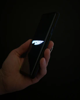 A tired professional happily receiving a quick meal suggestion on their phone in a cozy kitchen.