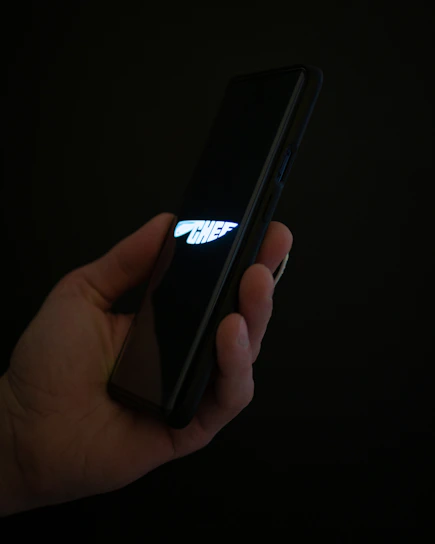 Close-up of a chef scanning a food label with a smart device in a modern kitchen.