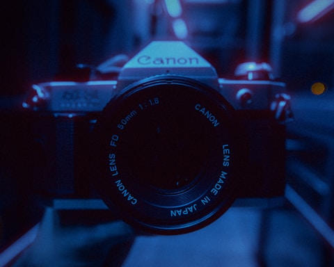 black nikon dslr camera on table