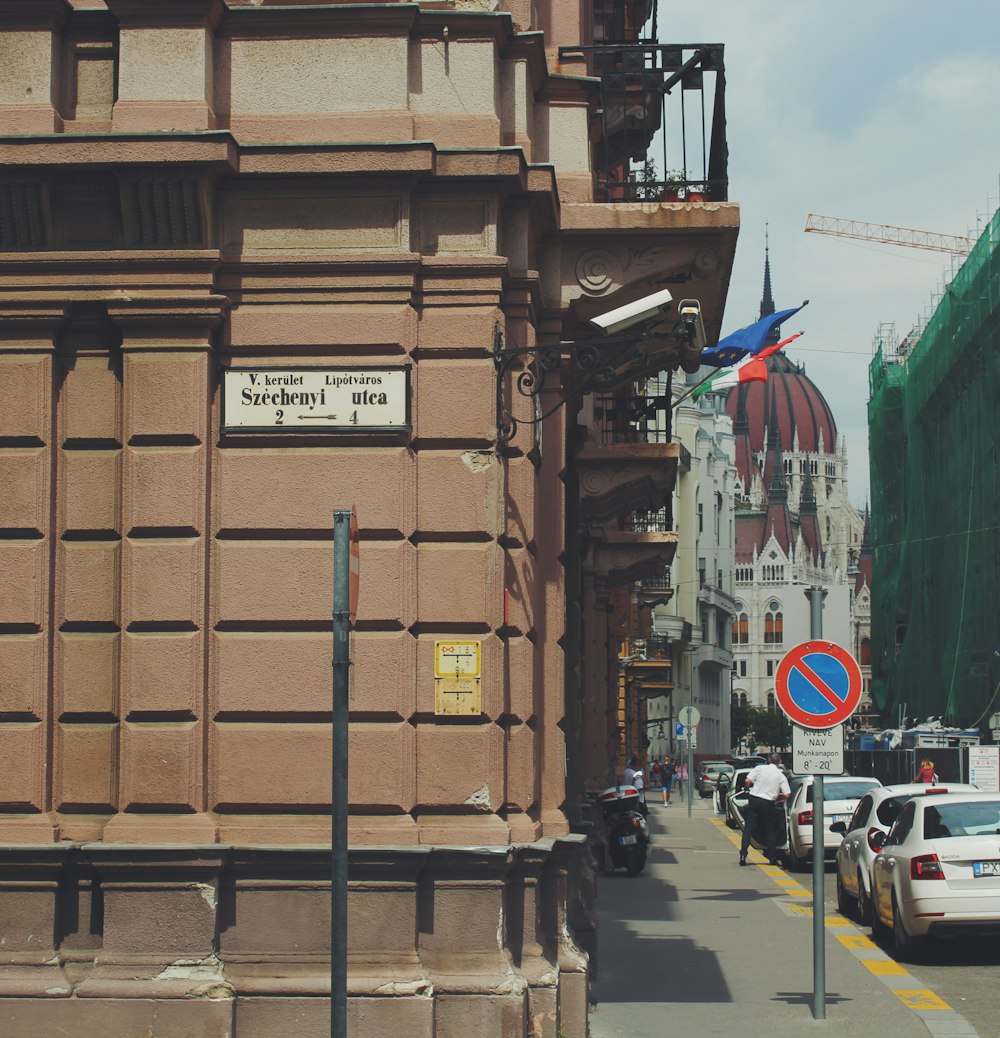 cars parked on side of the road near building during daytime