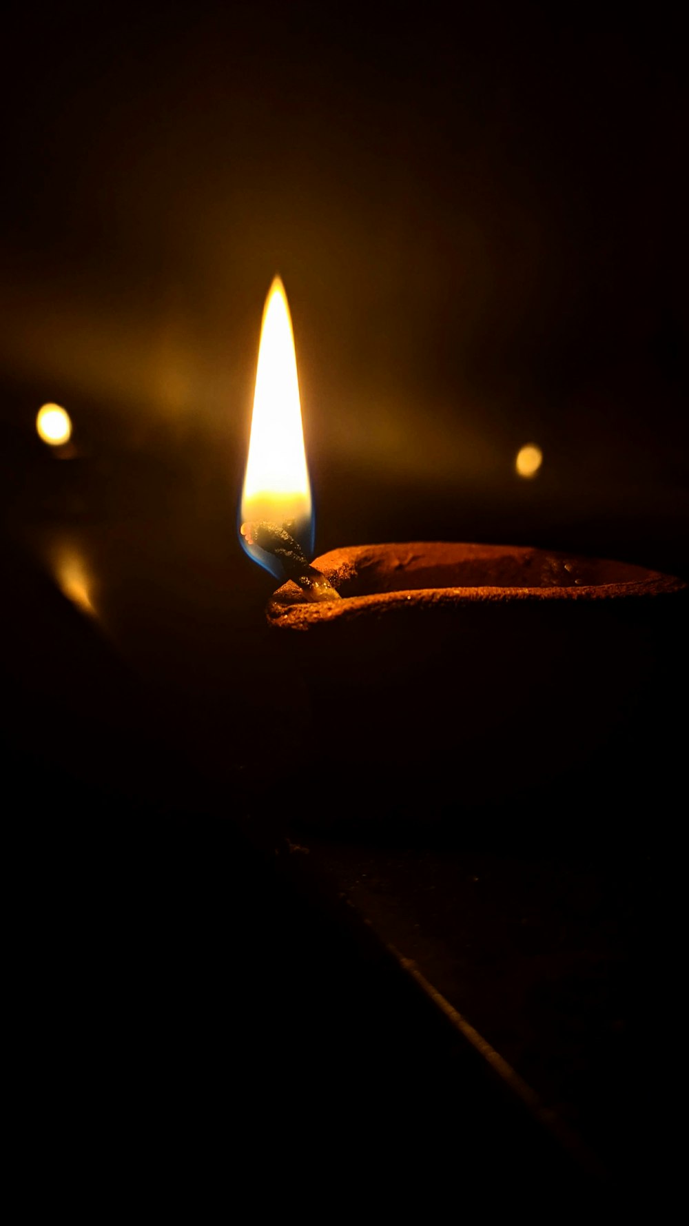 lighted candle in dark room