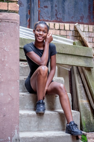 Casual outfit featuring a stylish windbreaker paired with sneakers on a concrete staircase