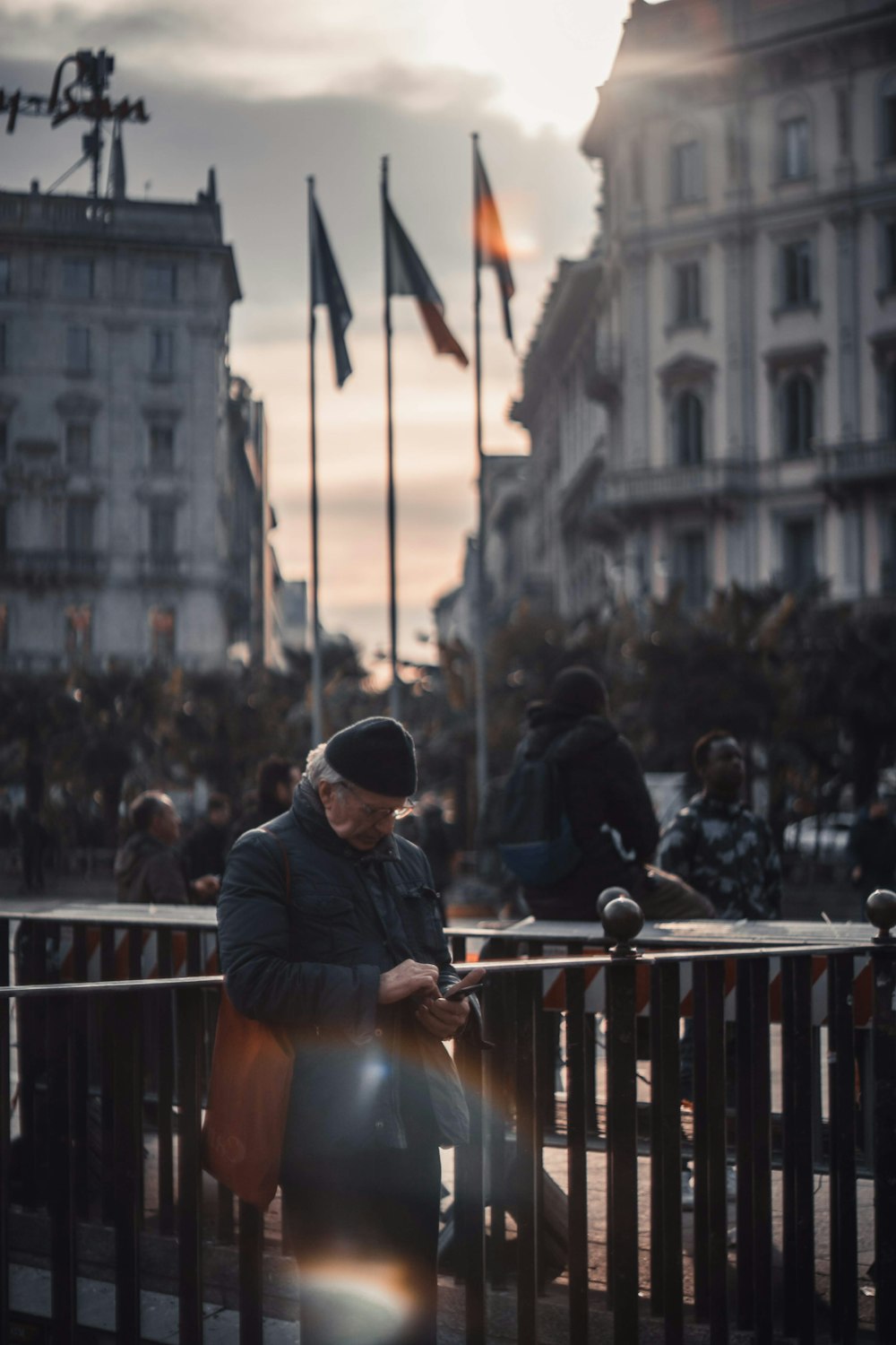 man in black jacket standing near people during daytime