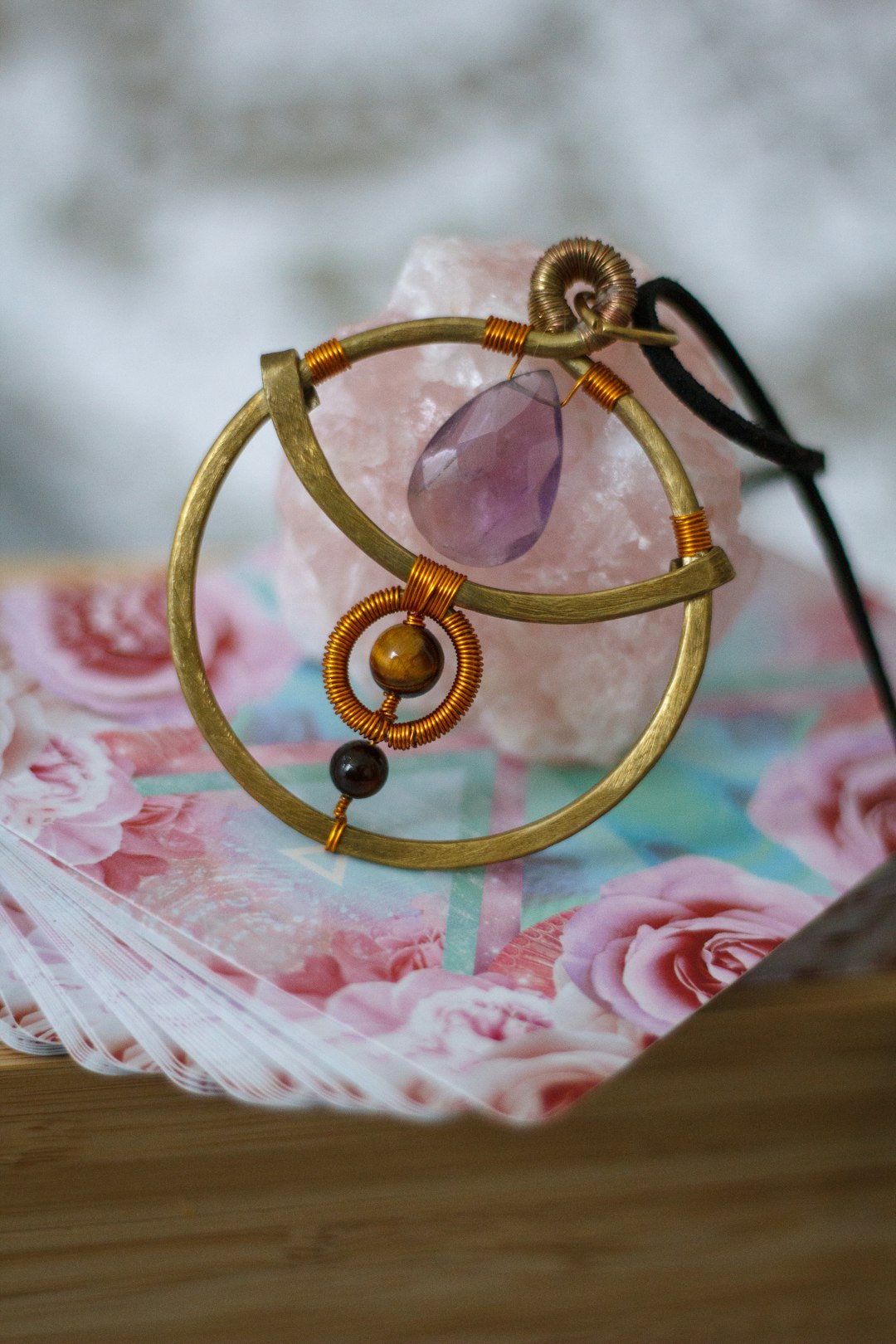 gold round frame on pink and white floral textile