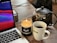 A calm and cozy home office setup with a laptop and a cup of tea, symbolizing online therapy.