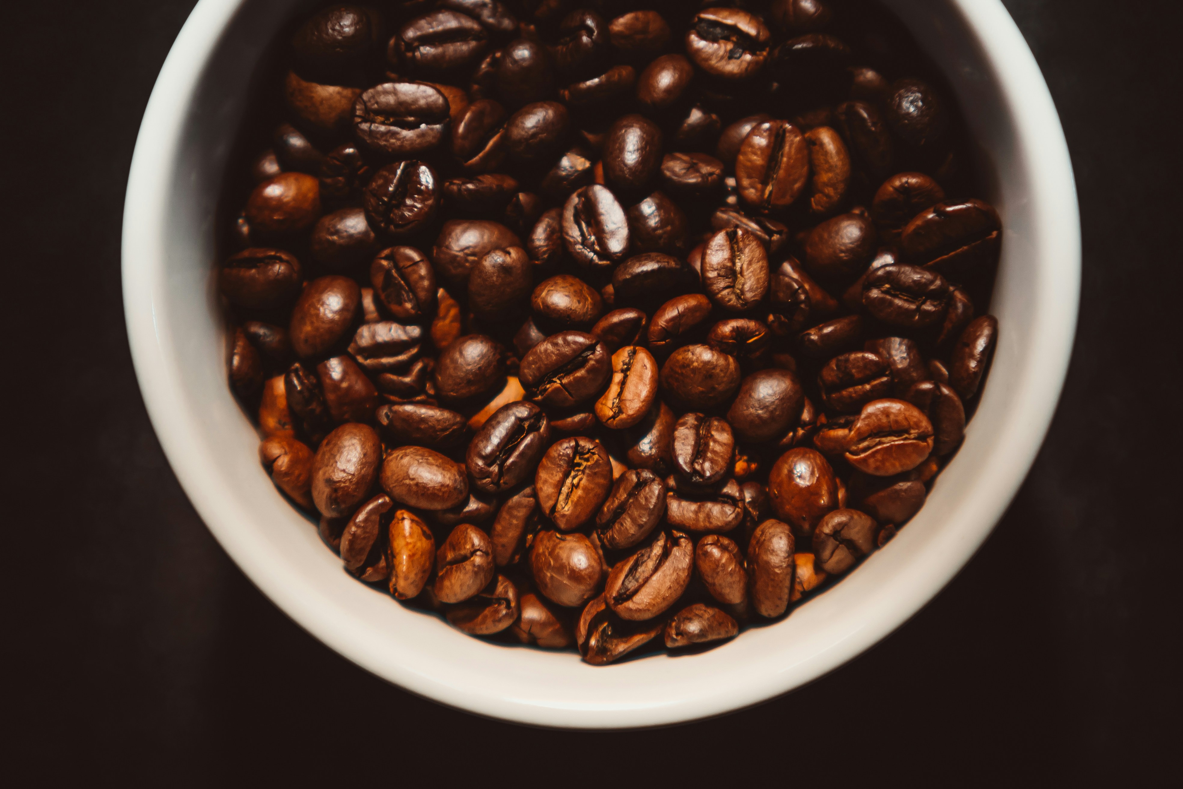 coffee beans in white ceramic bowl
