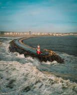 sea waves crashing on shore during daytime