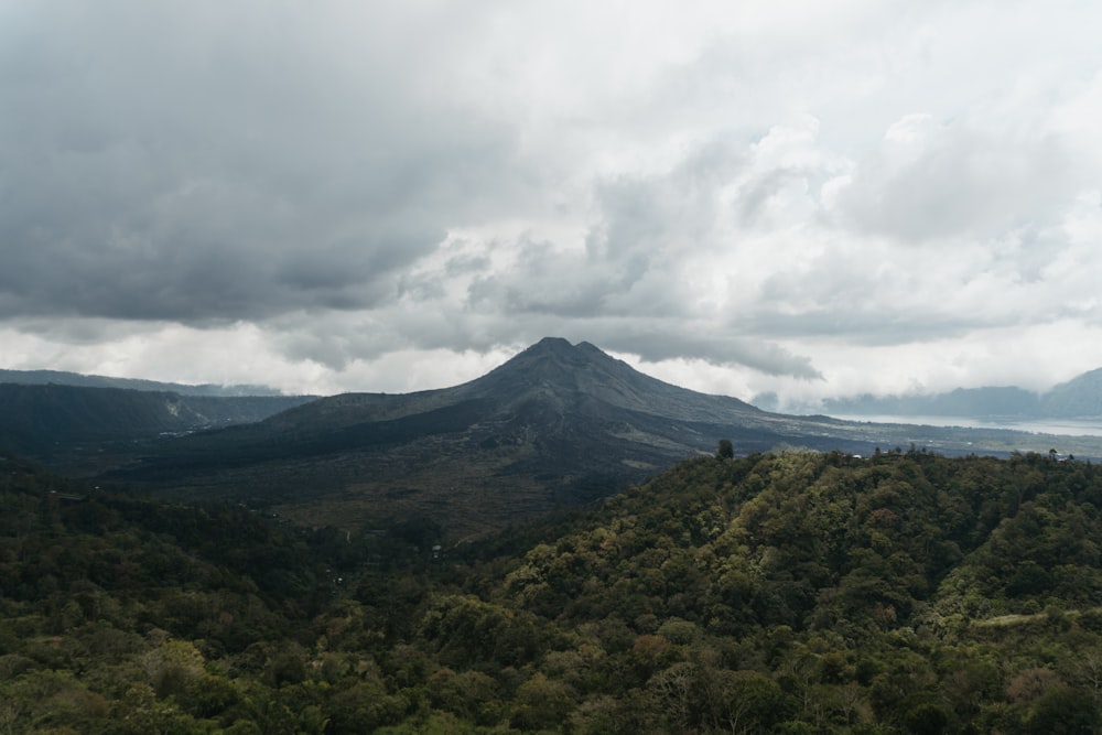 green mountain under white clouds during daytime