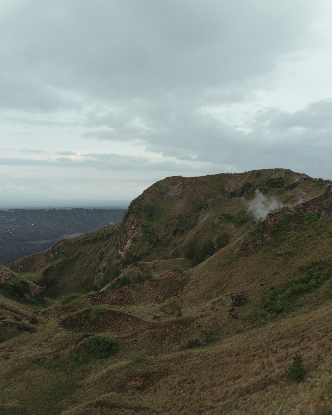 green and brown mountain under white clouds during daytime