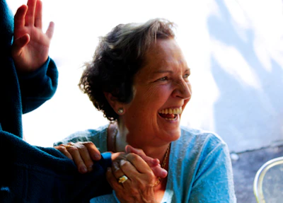 A happy client sharing a laugh with the Lumina Artis team after treatment.