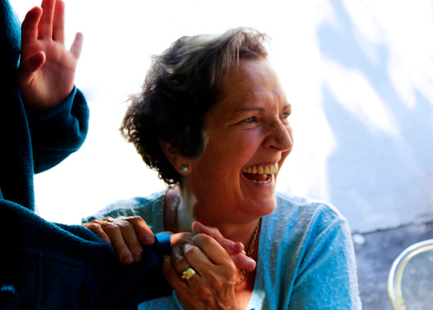 Myrna and her partner sharing a moment of laughter during a live online course session.