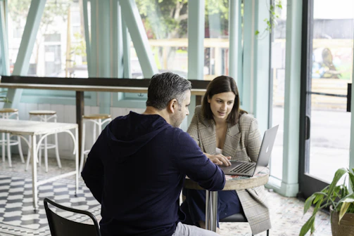 A candid moment of a team member discussing strategies over coffee in a modern café.