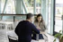 man in black long sleeve shirt sitting on chair beside woman in black and white stripe