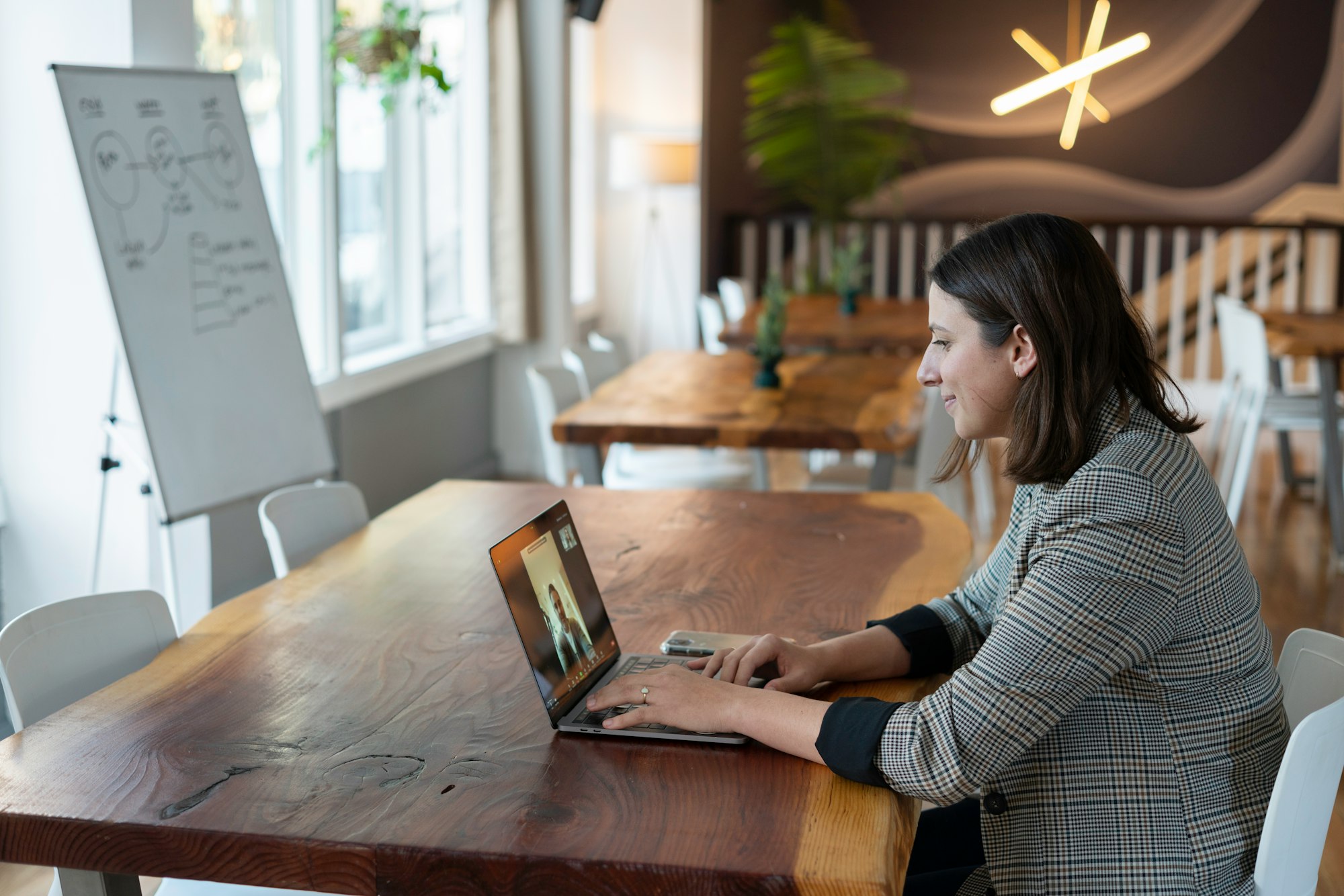 A salesperson working in an office on a virtual call