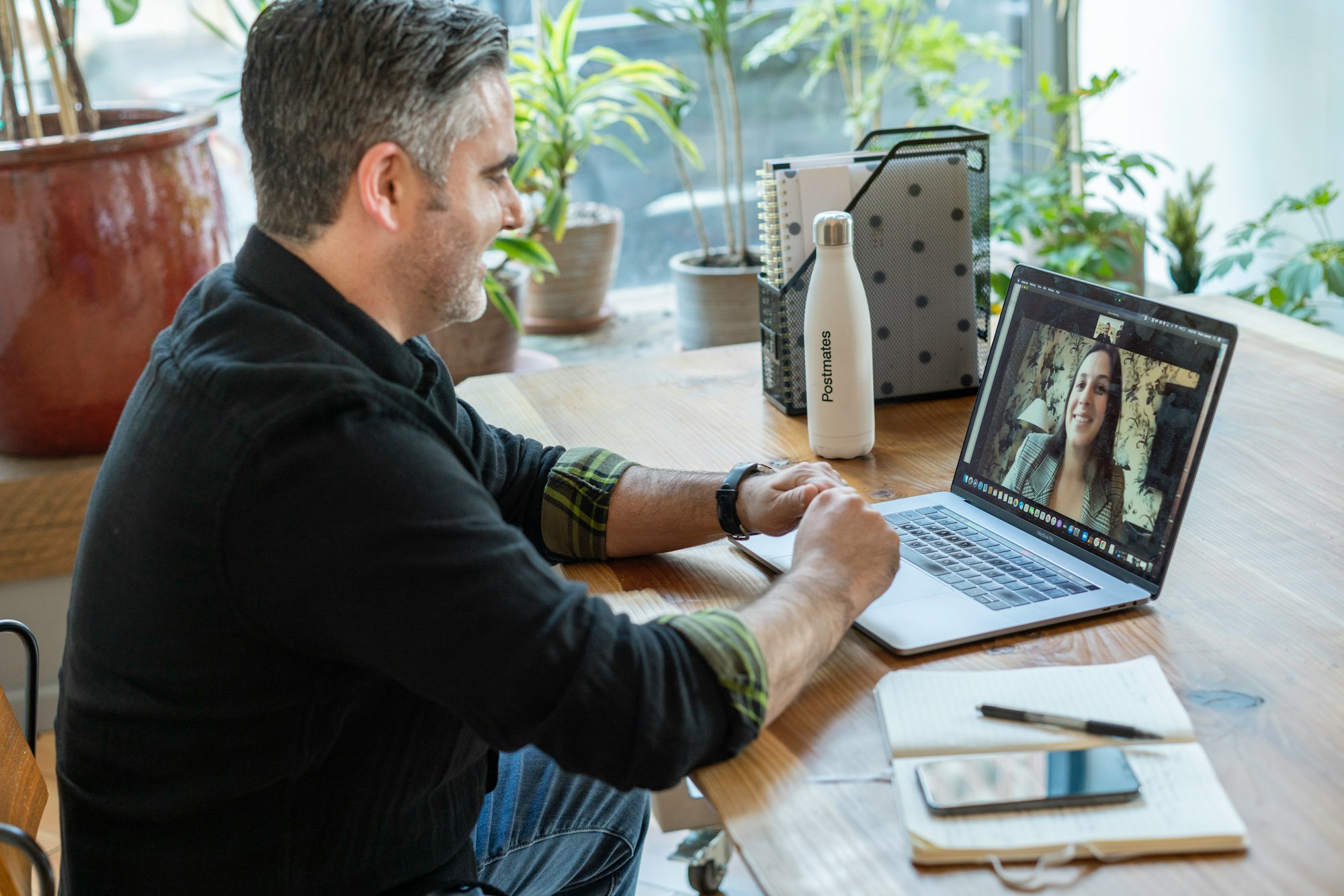 A salesperson working in an office on a virtual call